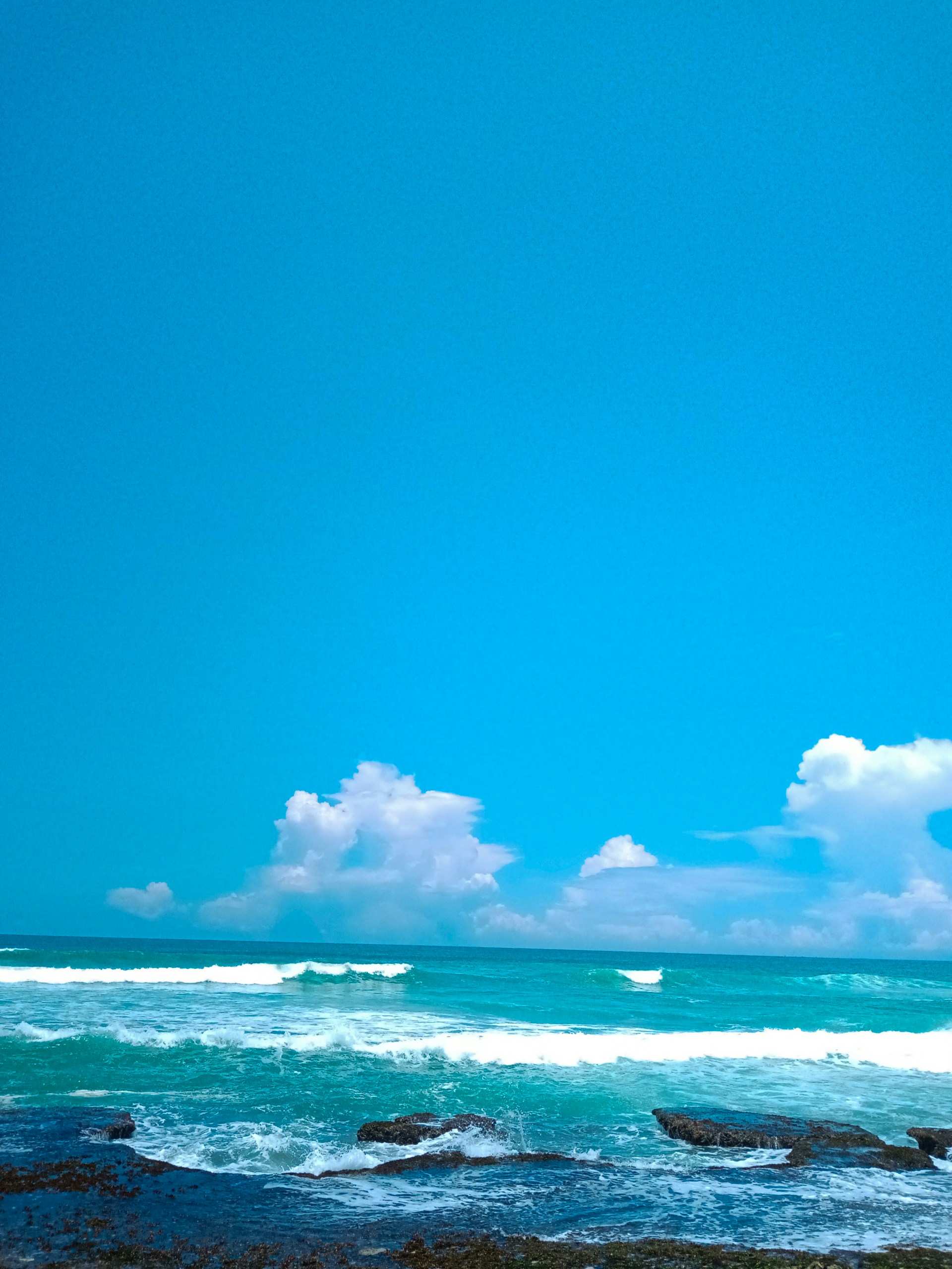 blue ocean under blue sky during daytime